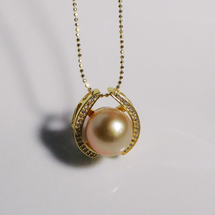 Golden Embrace pendant with vivid gold South Sea pearl in pavé horseshoe setting from GRACE SELECTED