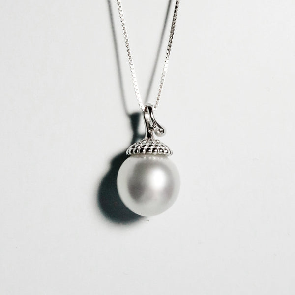 Near-round South Sea pearl with bright lustre and delicate pink tones in playful sterling silver pendant