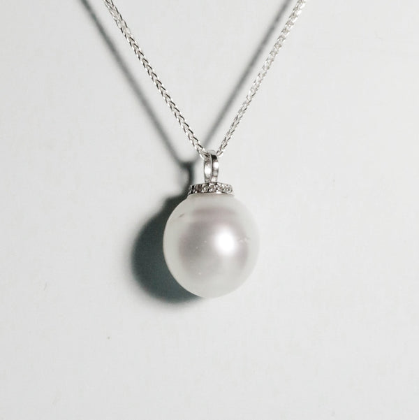 Oval South Sea pearl with excellent lustre and moderate natural blemishes, set in minimalist silver design