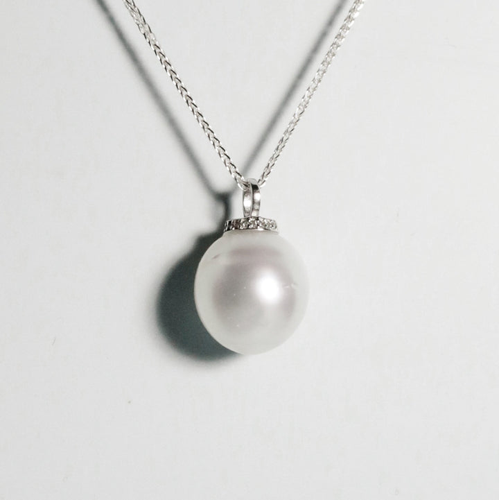 Oval South Sea pearl with excellent lustre and moderate natural blemishes, set in minimalist silver design