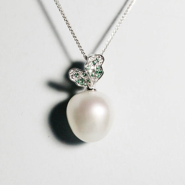 Front view of Fresh Picked pendant featuring white South Sea pearl and green zirconia leaf design