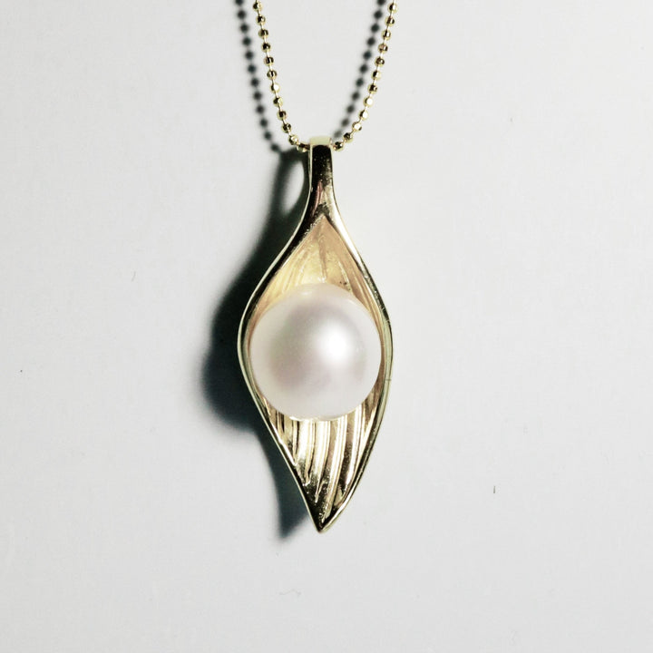 Front view of Whispering Leaf pendant with white South Sea pearl and gold-plated leaf design